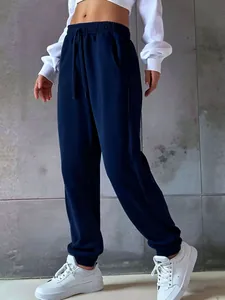 Detailed close-up of navy blue women's drawstring sweatpants featuring elasticated ankle cuffs