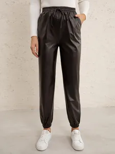 Black faux leather joggers featuring an elastic drawstring waistband and tapered ankle cuffs