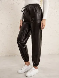 Detailed view of women's black PU leather joggers with elastic waist and drawstring.
