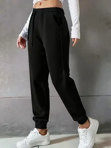 Side view detail of women's black high-waisted joggers featuring drawstring and ribbed cuffs