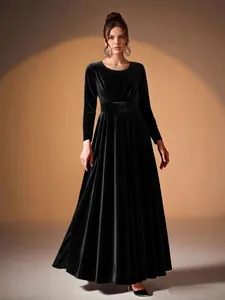 Elegant black velvet long-sleeved evening gown with pleated A-line skirt and waist belt.