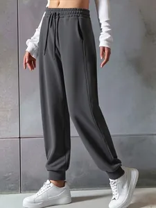 Detailed view of women's dark gray drawstring sweatpants with elastic waist and cuffs