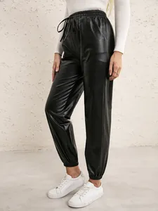 Close-up detail of women's black PU leather joggers with elastic drawstring waist.