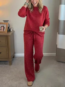 Detail view of red glittery loungewear set featuring cozy sweatshirt and wide pants