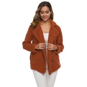 Detail showing the soft teddy fleece texture and elegant double-breasted button design