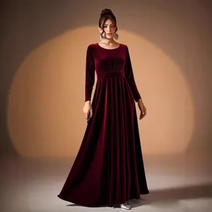 Elegant burgundy long-sleeved velvet evening gown with pleated waist and floor-length skirt