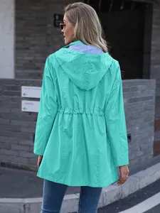 Detailed back view of a women's mint green hooded windbreaker with drawstring waist