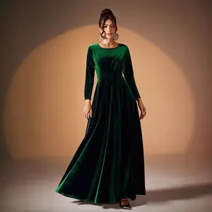 Elegant emerald green velvet long-sleeved evening gown with pleated waist.