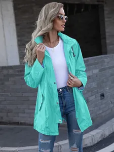 Close-up detail of the mint green mid-length raincoat with hood and drawstring waist