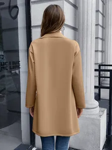Rückansicht eines kamelfarbenen, mittellangen Strickblazers im urbanen Straßenstil