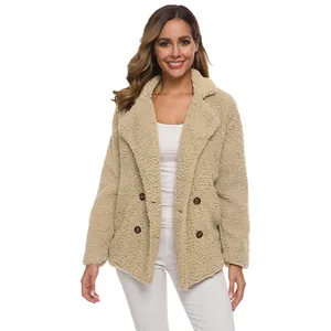 Detailed texture of women's beige teddy faux fur coat with double-breasted buttons