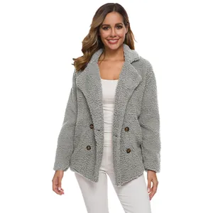 Front view of a grey double-breasted teddy fleece coat worn by a model in a studio