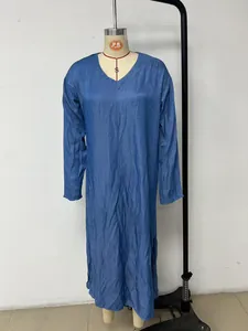 Detail view of a V-neck denim blue maxi dress with side slit on a mannequin