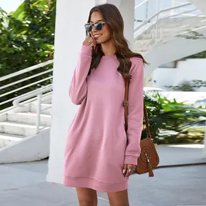 Casual pink long-sleeve sweatshirt dress styled outdoors with sunglasses and bag