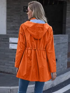 Back view of a women's orange mid-length hooded rain jacket with drawstring waist