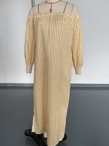 Full-length view of a striped off-the-shoulder long sleeve maxi dress on a mannequin