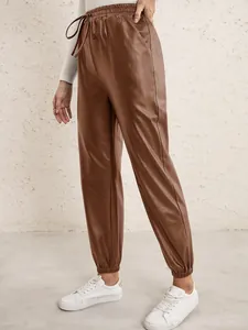 Detail showing women's brown PU leather jogger pants with elastic drawstring waist