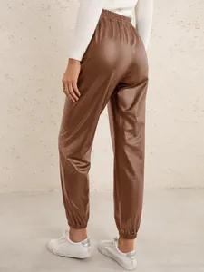 Back view of brown PU leather jogger pants with elastic waist and cuffed hems