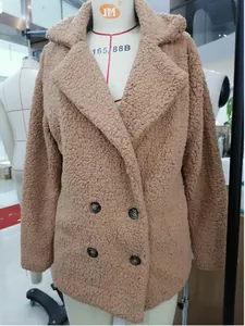 Detailed front view of a brown double-breasted sherpa fleece coat on a display mannequin.