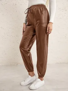 Close-up detail of women's brown PU leather joggers with elastic drawstring waist
