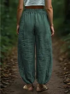 Back view of green linen-textured lantern pants with comfortable elastic waistband