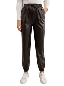 Detail view of women's black PU leather jogger pants with elastic drawstring waist.