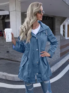 Outdoor lifestyle shot of a woman in a blue hooded mid-length raincoat jacket
