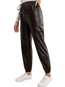 Detail view of women's black PU leather joggers featuring elastic drawstring waist and cuffs