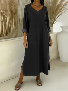Elegant black V-neck loose denim-style midi dress with chic side slits for women.