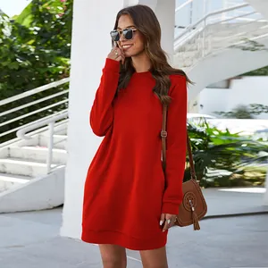 Outdoor street style view of a woman wearing a red long sleeve mini sweatshirt dress