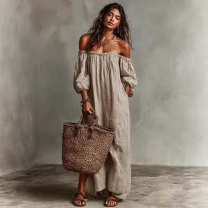 Detail view of a striped off-the-shoulder maxi dress with long bubble sleeves and a boho vibe.