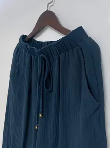 Detailed macro view of dark blue loose lantern pants featuring elastic drawstring waistband
