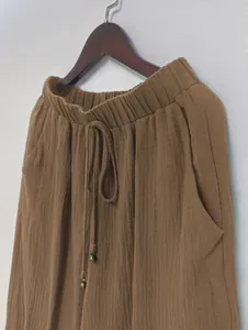 Detail shot of brown cotton linen lantern pants with elastic drawstring waist and pocket.
