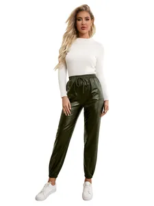 Full-body view of dark green PU leather joggers with elastic waist and white top.