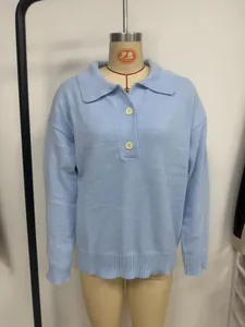 Detail view of a light blue knitted sweater with lapel and button placket detail
