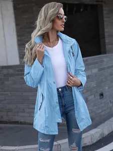 Detailed view of women's light blue hooded raincoat featuring zipper and button closure