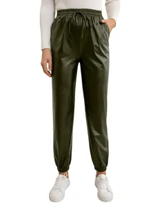 Close-up of dark green faux leather joggers with elastic high waist and drawstring.