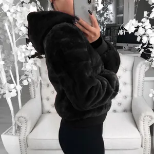 Détail d'une veste noire en fausse fourrure à capuche avec texture douce type vison.