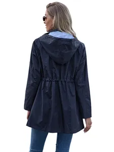Back view of a women's navy blue mid-length hooded raincoat with drawstring waist design.