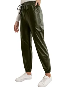 Side view of olive green PU leather joggers with elastic waist and drawstring detail