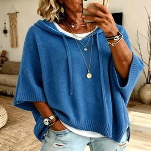Close-up detail of women's loose blue knitted hooded sweatshirt featuring a drawstring