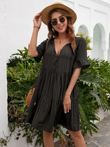 Stylish black V-neck casual midi dress with ruffle sleeves in an outdoor setting.
