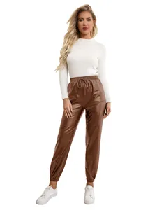 Full-length shot showing the fit and finish of brown PU leather jogger pants