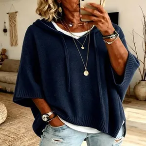 Detail of navy blue knit hooded poncho with drawstrings and ribbed hem for women