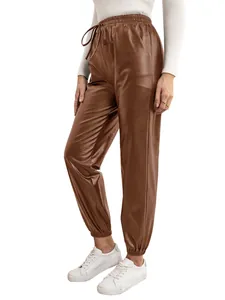 Close-up detail of women's brown faux leather jogger pants with elasticated drawstring waist