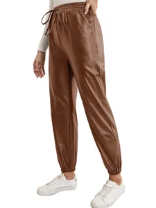 Full view of women's brown PU leather joggers featuring elastic waist and drawstring.