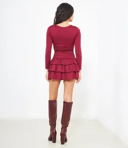 Back view of a elegant burgundy long-sleeved mini dress featuring a tiered ruffled skirt