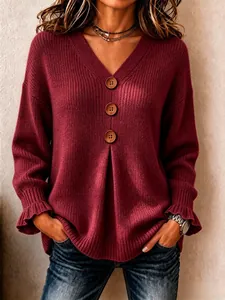 Close-up of wine red V-neck knit sweater with decorative wooden buttons and ruffles