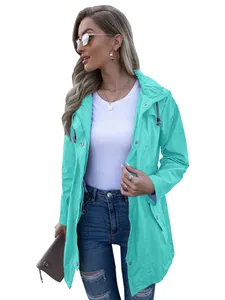 Close-up detail of women's mint green hooded raincoat with zipper and snap buttons