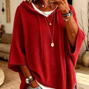 Cozy and elegant red oversized knitted hooded poncho with stylish drawstring details